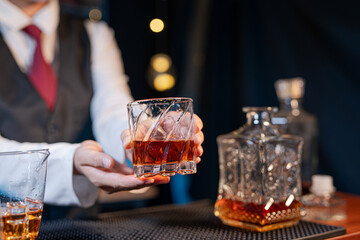 Professional female bartender preparing alcoholic drinks in a bar
