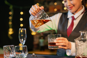  Professional female bartender preparing alcoholic drinks in a bar