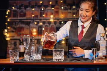  Professional female bartender preparing alcoholic drinks in a bar