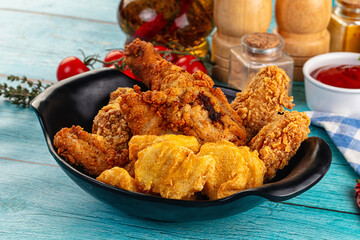 Golden crispy fried chicken mix - wings, drumsticks, nuggets and strips