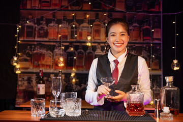  Professional female bartender preparing alcoholic drinks in a bar