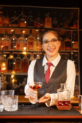  Professional female bartender preparing alcoholic drinks in a bar