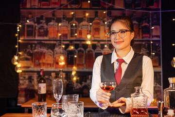  Professional female bartender preparing alcoholic drinks in a bar