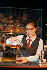  Professional female bartender preparing alcoholic drinks in a bar