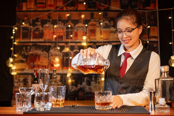  Professional female bartender preparing alcoholic drinks in a bar