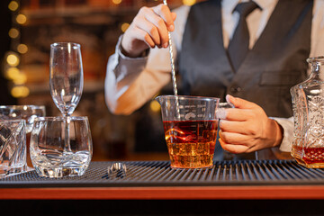 Professional female bartender preparing alcoholic drinks in a bar