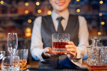  Professional female bartender preparing alcoholic drinks in a bar