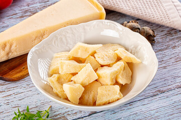 Parmesan cheese pieces in the bowl