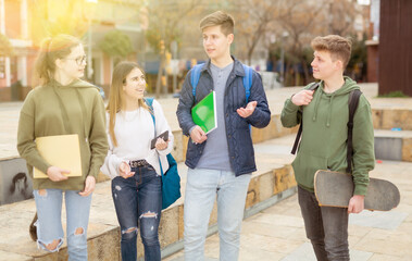 Teenagers have fun talking on the street