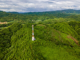 Telecommunication Tower in Remote Green Landscape – Digital Connectivity and Wireless Infrastructure in Rural Area