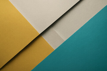 Abstract geometric background with layered teal, beige and golden yellow paper texture