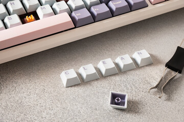 Concept cleaning keyboard. Mechanical keyboard with pastel keycaps on gray desk. Service. Changing,...