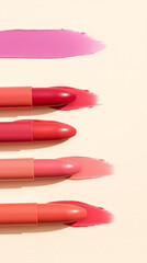 A collection of five lipstick swatches displayed on a beige background, showcasing various shades of pink and coral with smooth textures and subtle sheen, arranged horizontally for comparison.