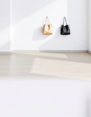 Minimalist interior scene featuring two handbags hanging on a white wall with a light wooden floor