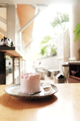 A perfect coffee break moment with a warm drink and a cookie, enjoyed in a bright, inviting cafe setting.