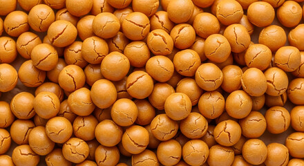 This image shows a dense collection of round, golden-brown peanut cookies.  Cracks adorn their surfaces, suggesting a crisp texture and tempting flavor, laid out as an abundant food background.