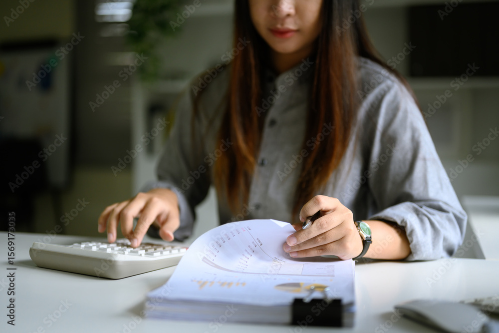 Poster sn accountant calculating and reviewing printed financial charts and data sheets