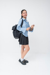 Young Southeast Asian student stands still, smiling at camera, wearing blue striped long sleeves,...