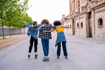 Group of young friends enjoying an afternoon skating and skateboarding together, symbolizing freedom, friendship, and urban lifestyle