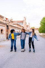 Obraz premium Three friends enjoying an afternoon together, skating and skateboarding in a city setting, showcasing youthful energy and urban leisure