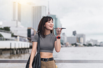 Happy solo southeast asian woman teenager blogger express to friend smartphone local cultural...