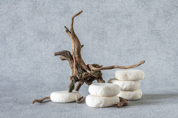 Empty stone podium, pieces of snag on grey background. Minimalist eco backdrop. Pedestal for product advertising. Wabi sabi concept. Copy space.