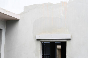 New coat of plaster on an exterior wall during house renovation project. Home improvement shows...