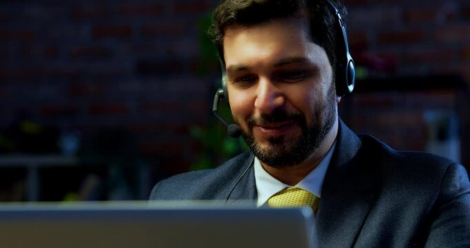 Indian businessman in call centre, Indian Asian corporate executive wearing headset and busy in communication, symbol of customer service, tech support, remote assistance, global connectivity