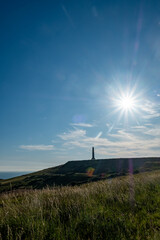 Cap Blanc-Nez, Escalles, Pas-de-Calais, Hauts-de-France, France, July 29th, 2025, A stunning view of a historical lighthouse atop a hill, surrounded by a vibrant sky and warm shining sun