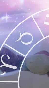 Animation of stars and zodiac moving over stones on white surface
