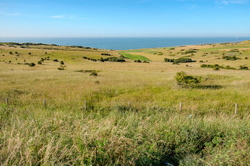 Cap Blanc-Nez, Escalles, Pas-de-Calais, Hauts-de-France, France, July 29th, 2025, A breathtaking and stunning view featuring green, rolling hills that meet the tranquil sea beneath a clear, blue sky