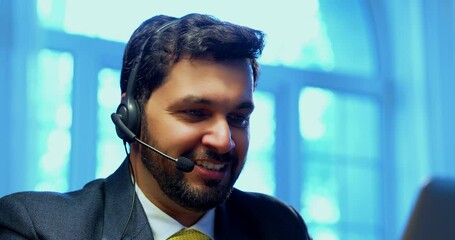 Indian businessman in call centre, Indian Asian corporate executive wearing headset and busy in communication, symbol of customer service, tech support, remote assistance, global connectivity - Powered by Adobe