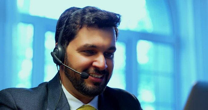 Indian businessman in call centre, Indian Asian corporate executive wearing headset and busy in communication, symbol of customer service, tech support, remote assistance, global connectivity - Powered by Adobe