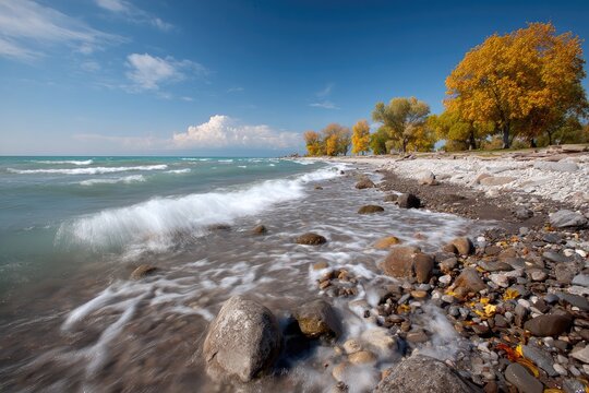 Autumnal lake shore, waves on pebbled beach - Powered by Adobe