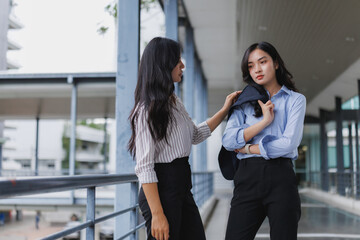 Businesswoman comforting her sad colleague in office building
