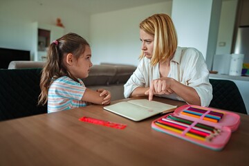 Young girl engaged in serious discussion with adult