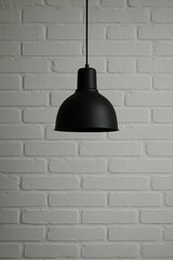 Obraz premium Vintage industrial lamp mounted on whitewashed brick wall