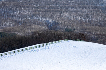 high-angle view of the snow-covered ranch in the mountain