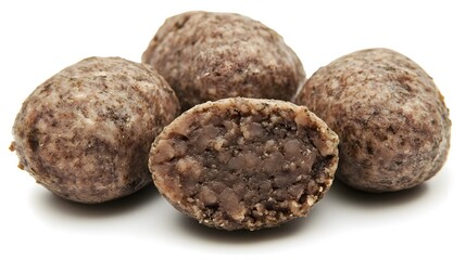 Photograph of four dark chocolate energy balls on a white background.