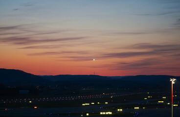 Scenic view of landscape with runway and taxiway of Swiss Airport Zürich Kloten at sunset. Photo...