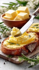 Close-up of smashed butter on a slice of bread resting on a wooden table, showcasing rich textures and colors at breakfast time