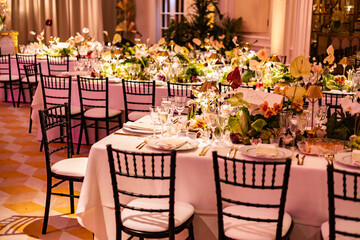 Elegant Wedding Reception with Floral Centerpieces and Golden Light