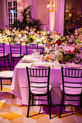 Elegant Wedding Reception with Floral Centerpieces and Golden Light