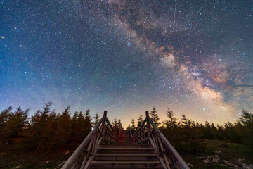 The wooden corridor on the mountain is under the stars