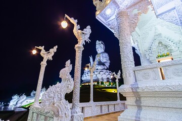 Guan Yin Statue and facade of Ubosot, Wat Huai Pla Kang, Chiang Rai, Thailand