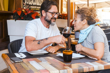 Happy couple enjoying meal at restaurant – romantic date, vacation mood, weekend vibes, relationship and quality time concept