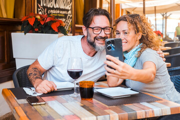 Happy couple enjoying meal at restaurant – romantic date, vacation mood, weekend vibes, relationship and quality time concept