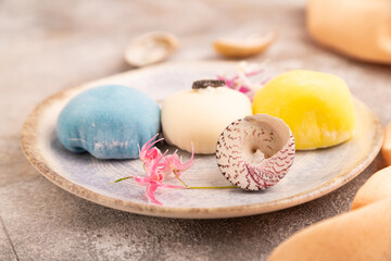 Japanese Mochi Cakes on brown concrete, orange textile, side view, close up, selective focus