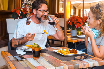 Happy couple enjoying meal at restaurant – romantic date, vacation mood, weekend vibes,...
