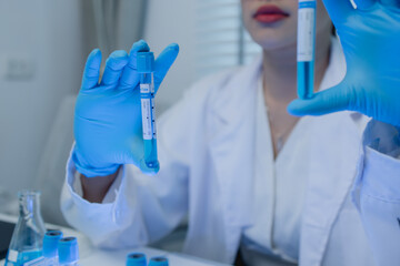 a female scientist is working in lab, a chemist tests liquid sample in science laboratory, she...